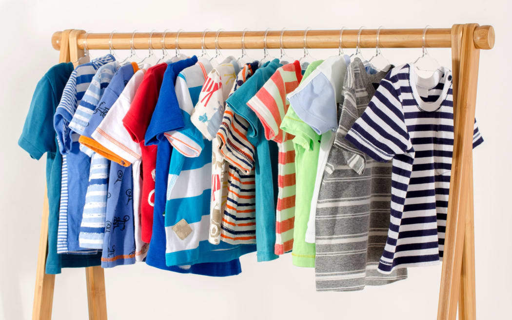 Children's clothing arranged on hangers.