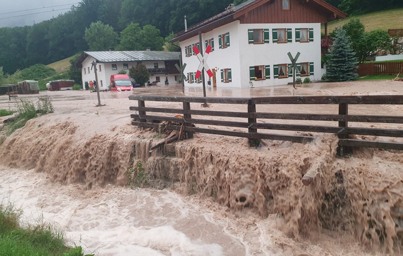 Water flows over a square in front of a house in Bavaria, Germany