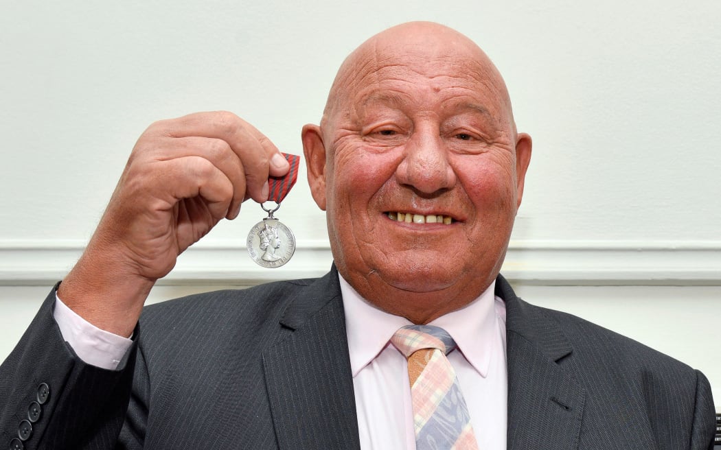 Former boxer Ronnie Russell poses for a photograph in London on 2 March, 2020, with the George Medal awarded to him for defending the life of Britain's Princess Anne, the Princess Royal, during a kidnap attempt on her life in 1974, ahead of its sale by auctioneers Dix Noonan Webb.