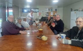 Group of pensioners gathered around for Friday drinks.