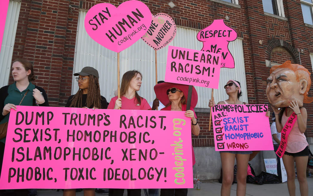 Protesters assemble on Lamar Street near Gilley's, in in Dallas, Texas, after Donald Trump arrived, intending to boost support.