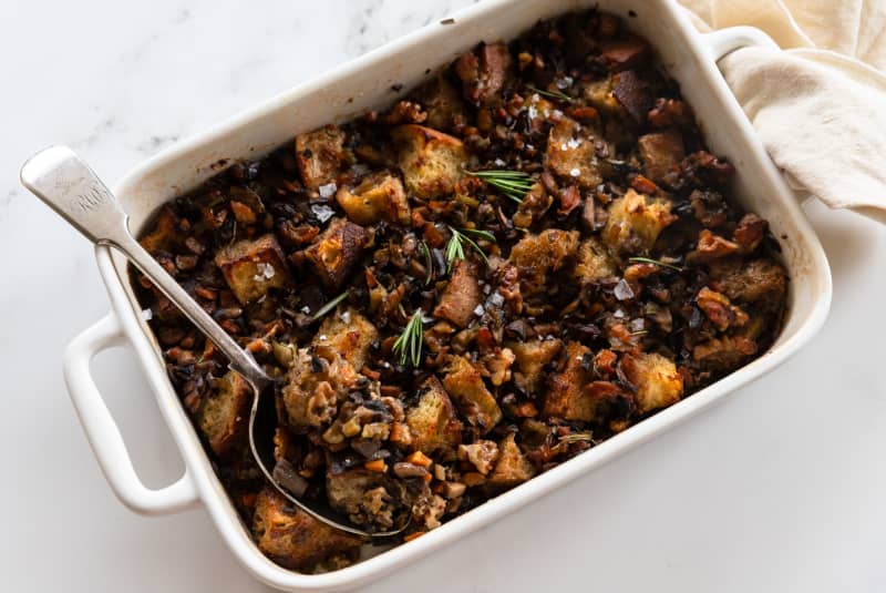 A rectangular baking dish containing Mushroom, rosemary and walnut sourdough stuffing.