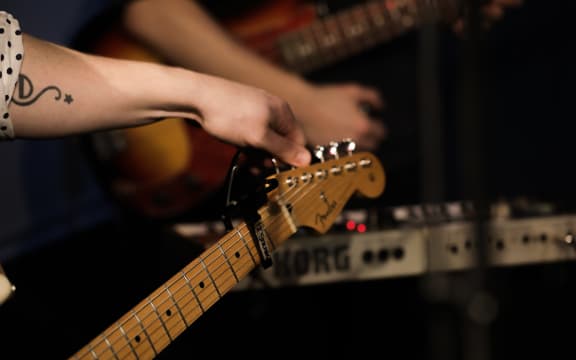 Edward Castelow of Dictaphone Blues tunes his guitar