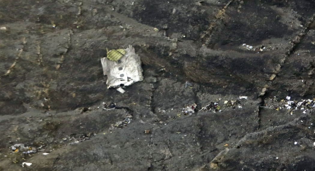 A handout picture made available by Thomas Koehler on 24 March 2015 shows wreckage and small debris lying on the mountainside after the crash of an Airbus A320.