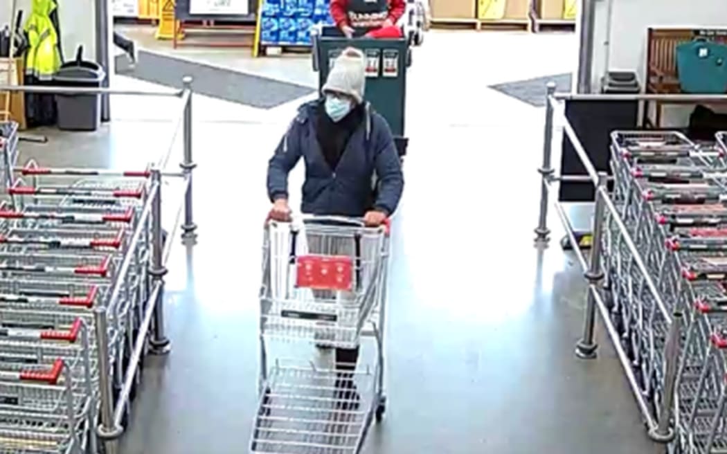 An image taken at Bunnings in Te Rapa, Hamilton, on Wednesday 2 August 2023, of the man police believe is Tom Phillips wearing a white beanie, a surgical mask and glasses.