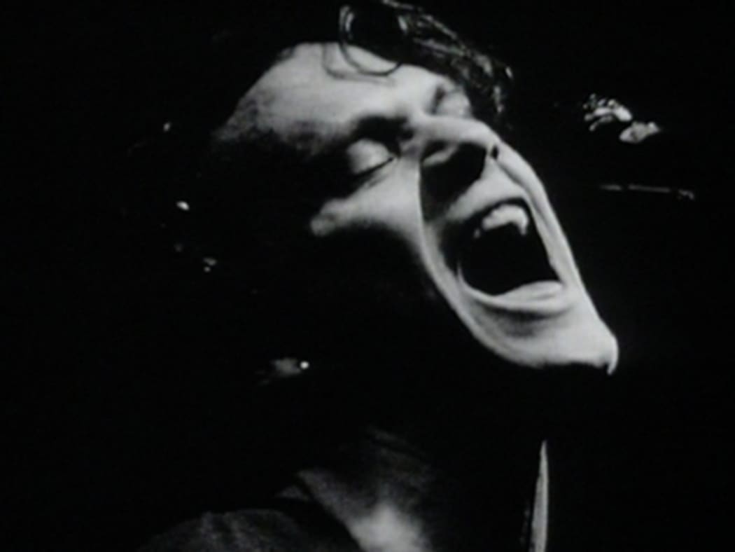 A black and white still shot of Shayne Carter from the 1992 music video for the single, 'Done'.