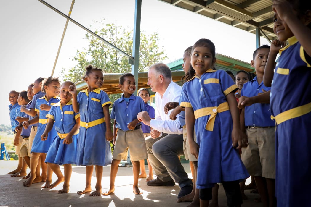 Speaker Trevor Mallard learns some new dance moves from the children at Koroipita Kindergarten in Fiji