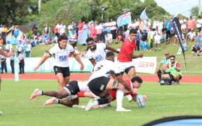 The Flying Fijians were made to work hard in Nuku'alofa on Friday, before three second-half tries made sure of a 50-19 defeat of Tonga and top spot in Pool A.