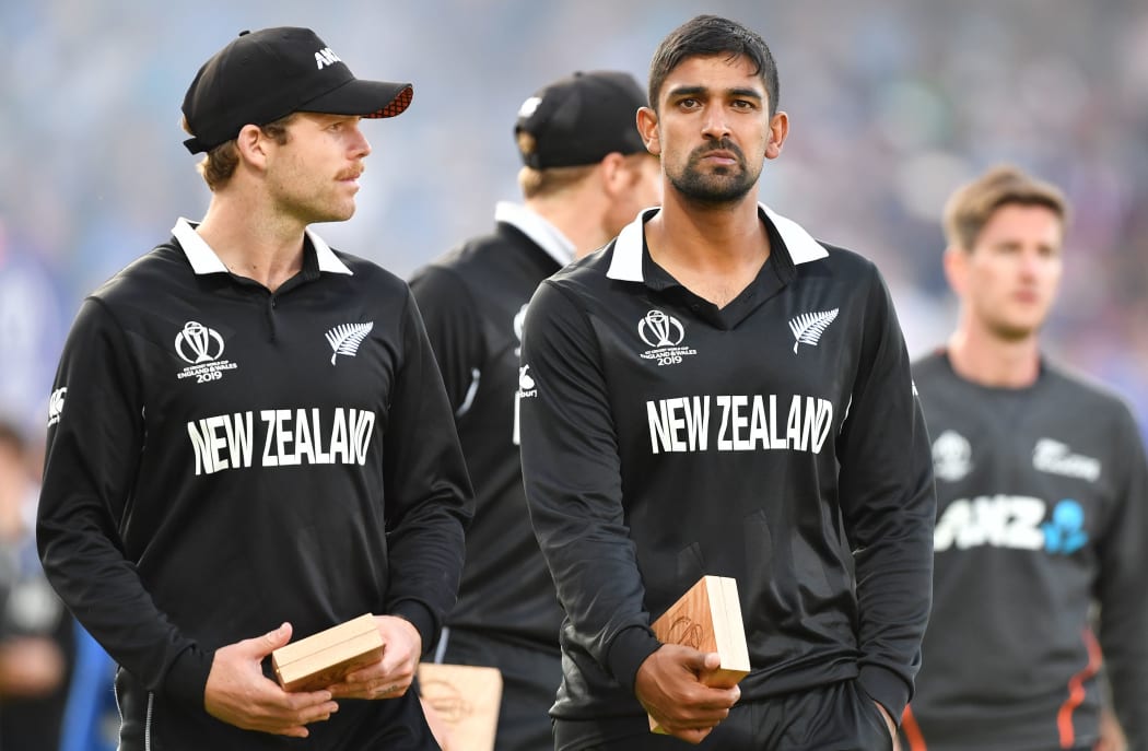 New Zealand's Lockie Ferguson (L) and New Zealand's Ish Sodhi (R) react to their defeat after the 2019 Cricket World Cup final between England and New Zealand at Lord's
