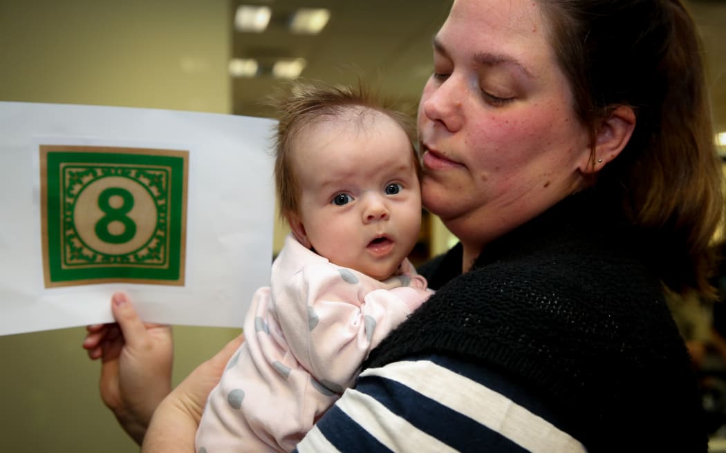 8 week old Zoe Butson-Couper and Jess Butson support the new paid parent bill that would give them a further eight weeks together.