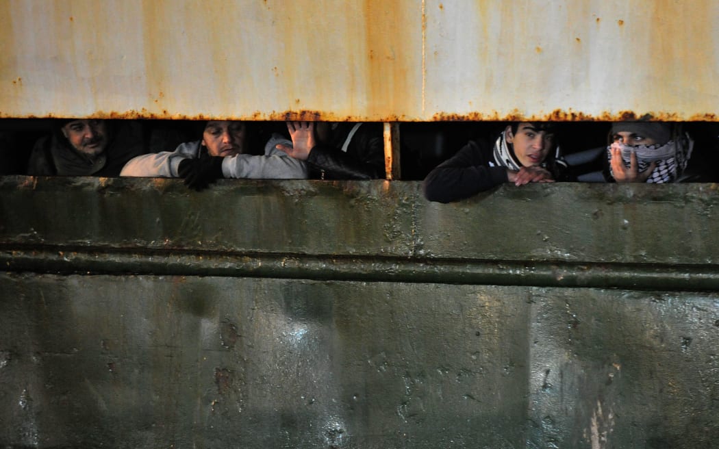 About 400 would-be immigrants arrive aboard the 'Ezadeen' at Corigliano Calabro, Italy.