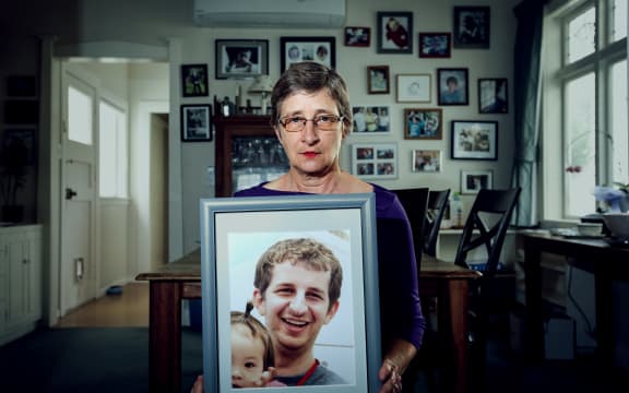 Kelly Savage's mother, Martha Savage holds a picture of her son. Kelly Savage died in in Japan after being restrained in a bed of a psychiatric hospital for 10 days.