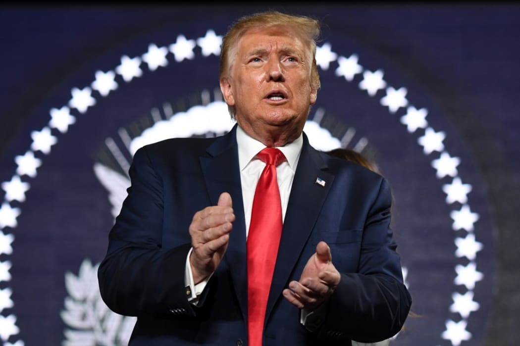 US President Donald Trump applauds as he attends Independence Day events at Mount Rushmore in Keystone, South Dakota, July 3, 2020. (Photo by SAUL LOEB / AFP)