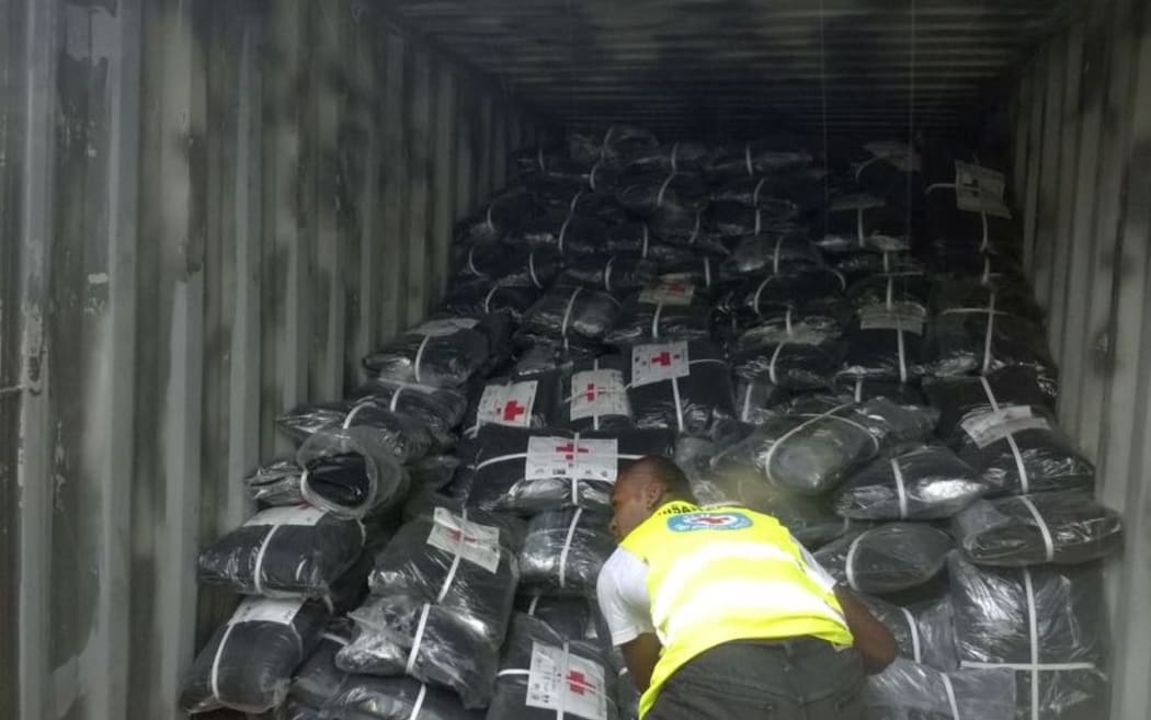Fiji Red Cross staff and volunteers get aid packages ready for distribution following Cyclone Winston