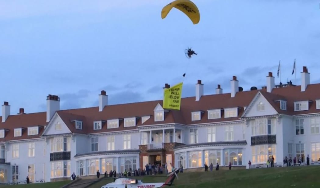A Greenpeace paraglider swept just over US President Donald Trump when he was visiting Scotland.