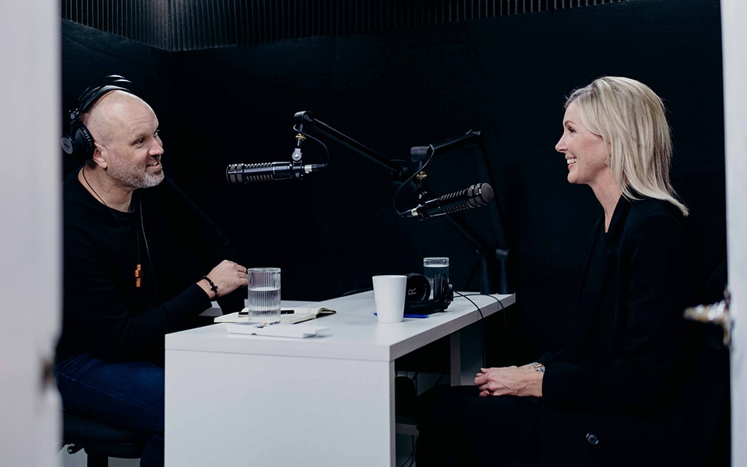 Rev. Frank Ritchie interviewing Rachel Smalley, host of Today FM's First Light programme, in a small recording studio.