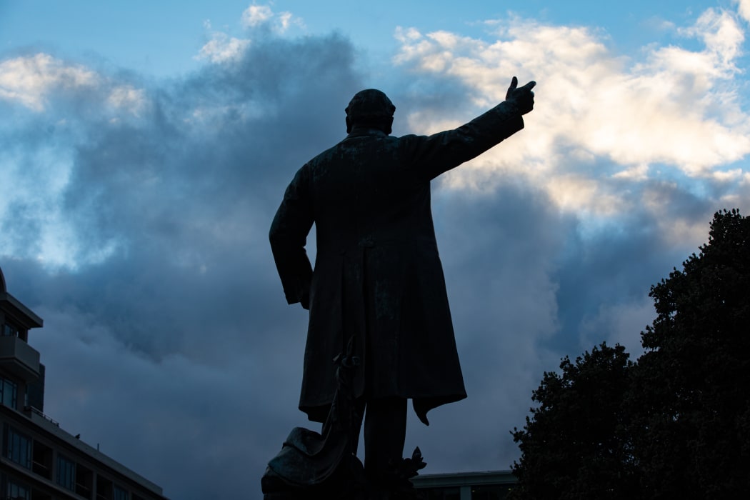 Parliament's statue of Richard Seddon silhouetted against the dawn