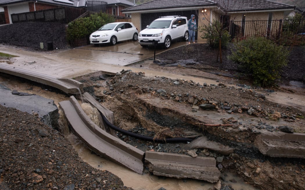 Flood waters have ripped open the road in Devenish Place, Atawhat, just north of Nelson