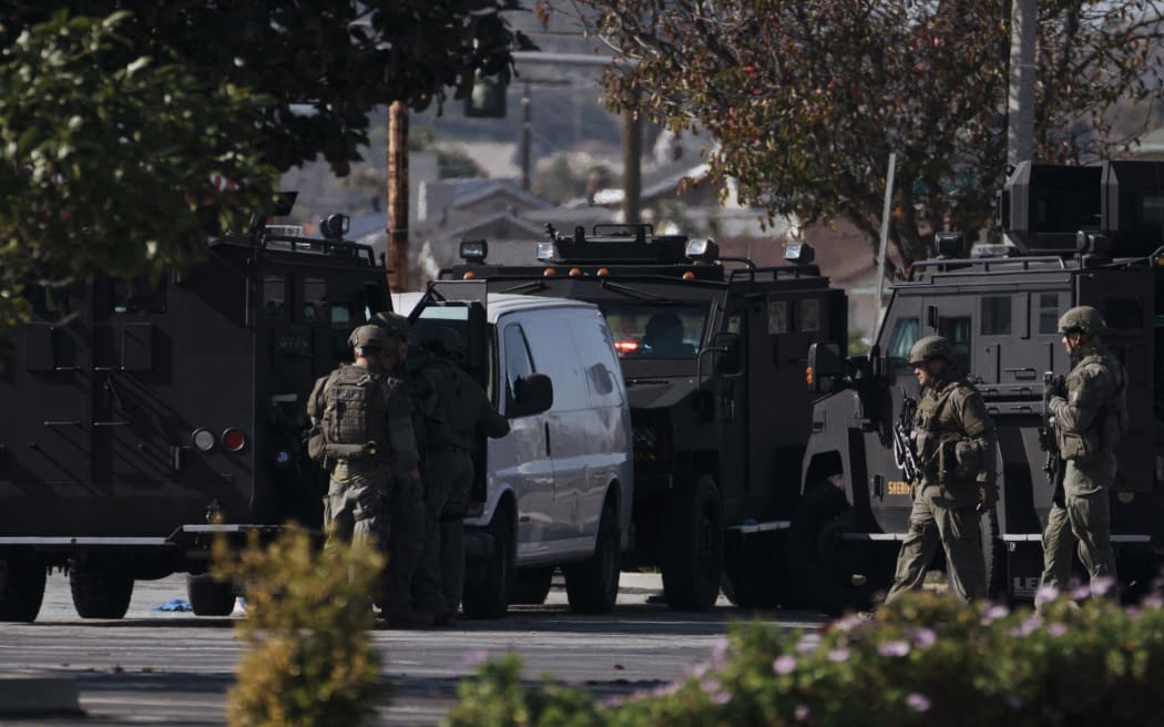 TORRANCE, CA - JANUARY 22: Law enforcement surrounds a white van in a parking lot that is being investigated for a possible connection to the earlier Monterey Park mass shooting on January 22, 2023 in Torrance, California. 10 people were killed and 10 more injured at a dance studio in Monterey Park near a Lunar New Year celebration on Saturday night.   Eric Thayer/Getty Images/AFP (Photo by Eric Thayer / GETTY IMAGES NORTH AMERICA / Getty Images via AFP)