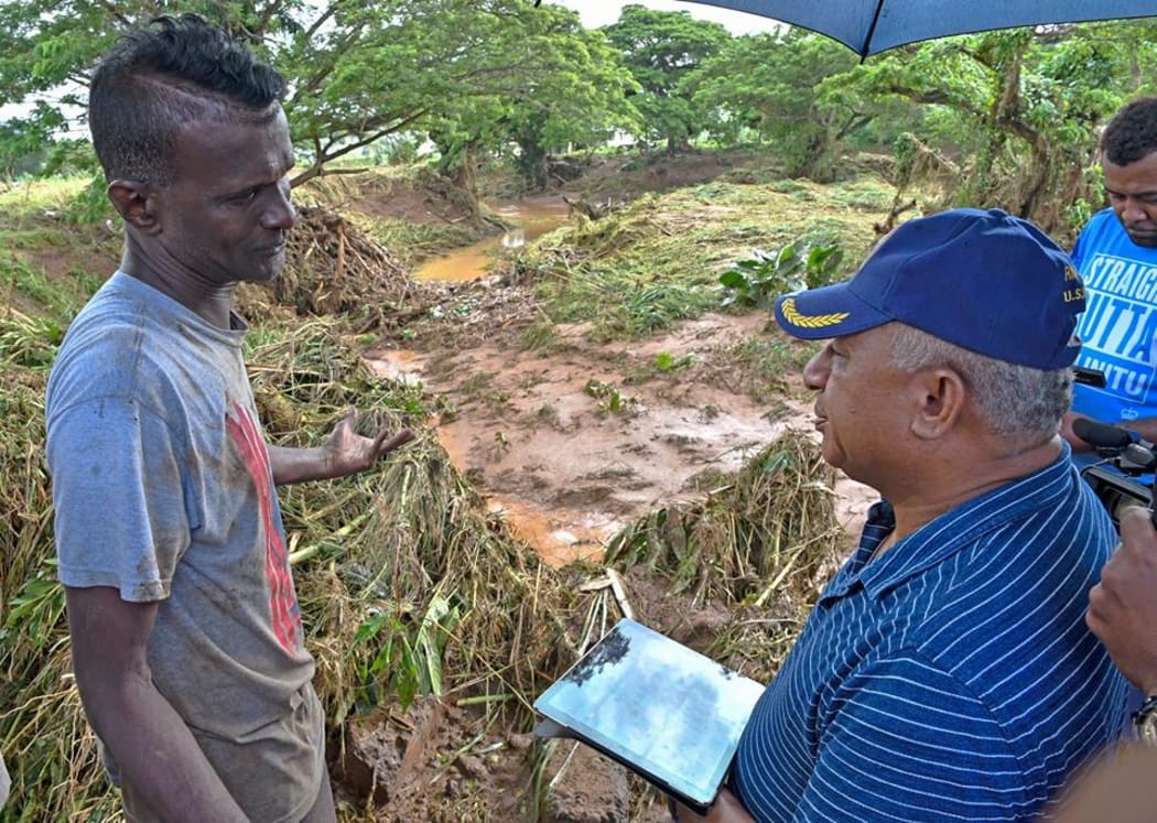 Richard Divendra (left) a resident of Yalalevu briefs the Prime Minister Frank Bainimarama at Yalalevu, Ba.
