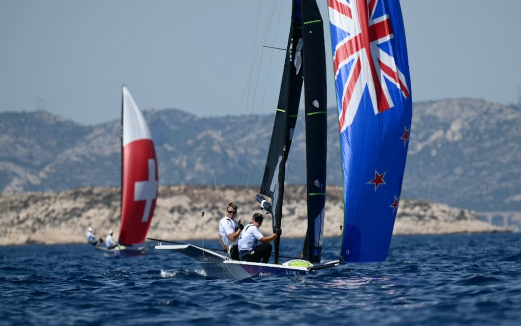 New Zealand's Isaac Mchardie and New Zealand's William Mckenzie arrive to win Race 1 of the men’s 49er skiff event during the Paris 2024 Olympic Games sailing competition at the Roucas-Blanc Marina in Marseille on July 28, 2024. (Photo by Christophe SIMON / AFP)