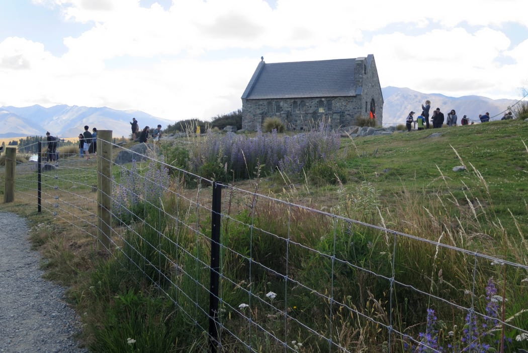 Tourists visit at the Church of the Good Shepherd in Tekapō.