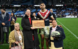 Tongan princess Angelika Tuku'aho, middle, presents Daniel Tupou with a gift at the player's 300th game at the weekend.
