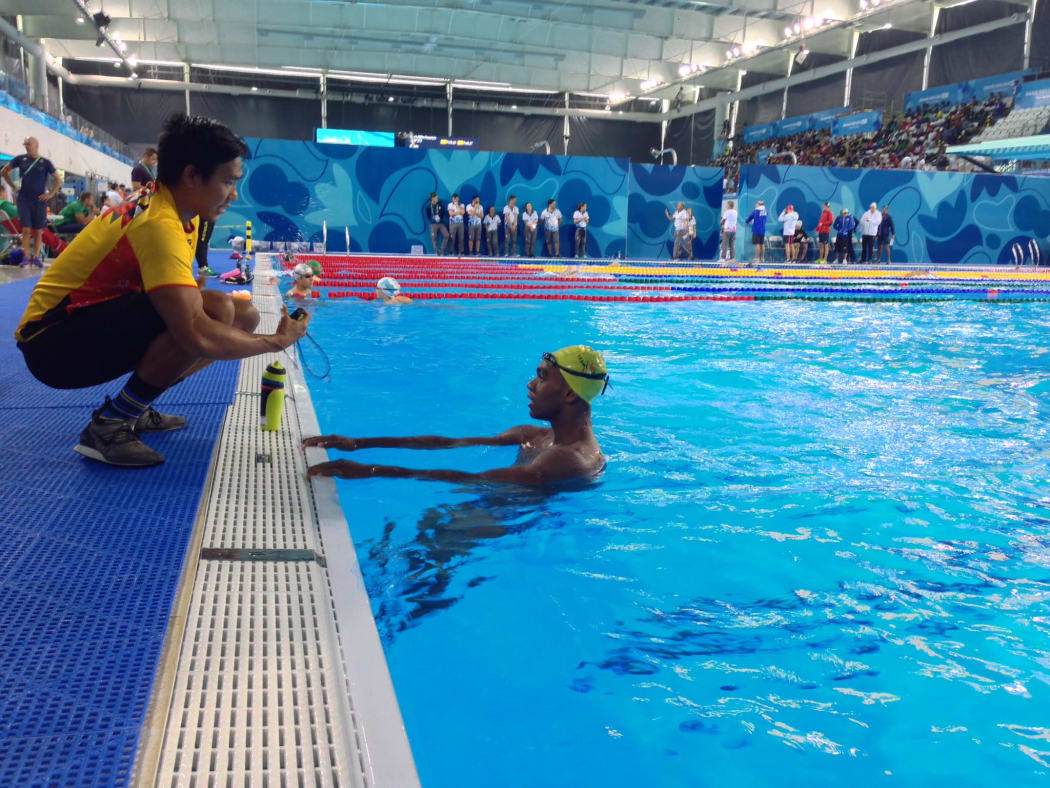 Papua New Guinea swimmer Leonard Kalate gets some last minute coaching advice in Buenos Aires.