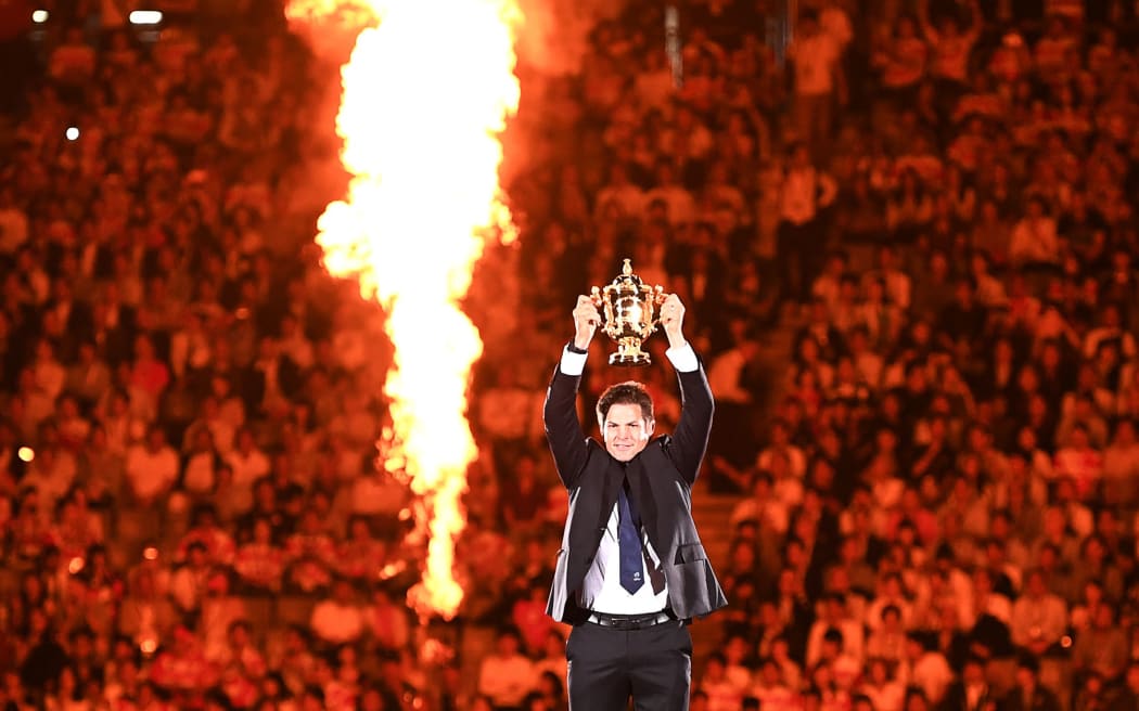 Former New Zealand international Richie McCaw holds the Rugby World Cup trophy during the tournament's opening ceremony at the Tokyo Stadium in Tokyo on September 20, 2019,