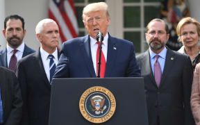 Surrounded by members of the White House Coronavirus Task Force, US President Donald Trump speaks at a press conference on COVID-19.