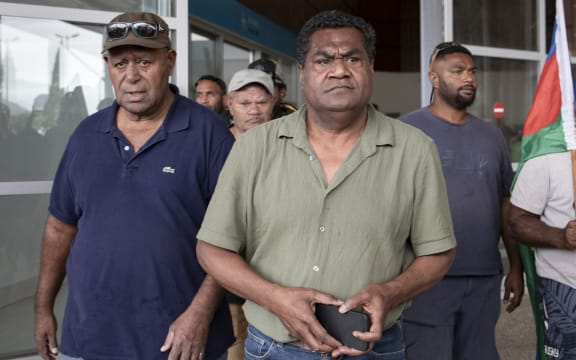 Kanak pro-independence leader Christian Tein (C), head of the CCAT (Cellule de Coordination des Actions de Terrain), leaves the Noumea - La Tontouta international airport in La Tontouta, south of Noumea, in France's Pacific territory of New Caledonia, on December 4, 2025. (Photo by Delphine MAYEUR / AFP)