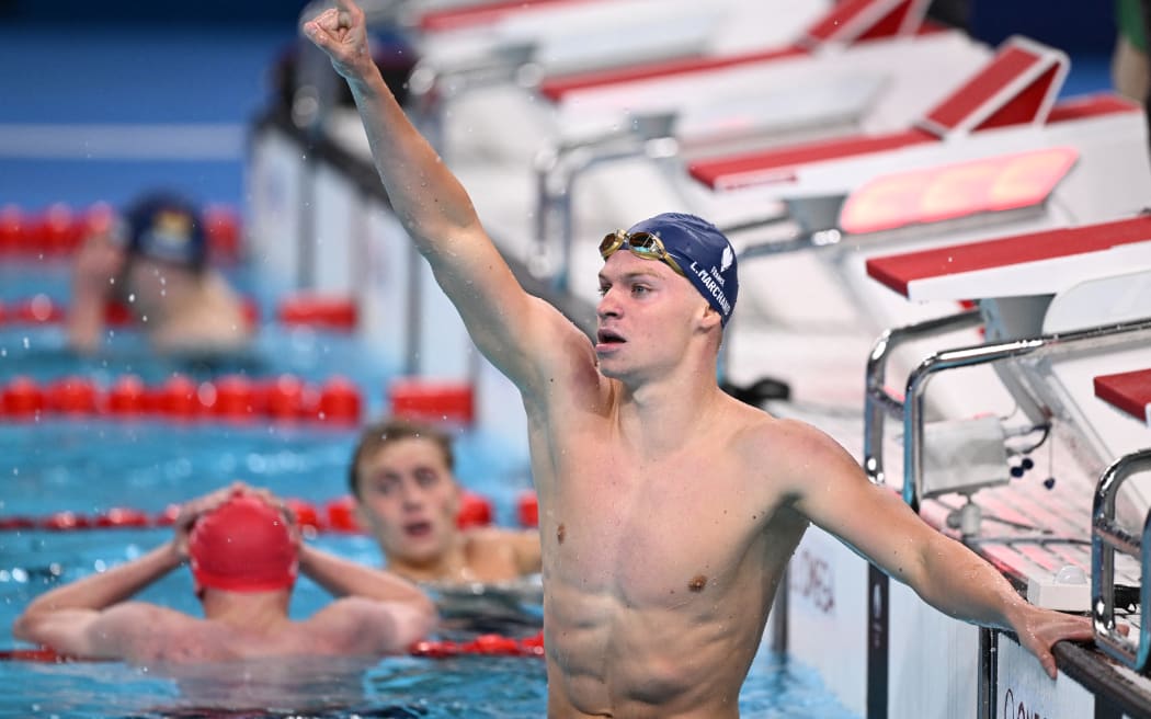 France's Leon Marchand celebrates after winning the final of the men's 400m individual medley swimming event during the Paris 2024 Olympic Games at the Paris La Defense Arena in Nanterre, west of Paris, on July 28, 2024.