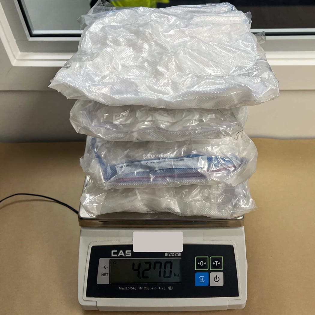 The intercepted methamphetamine from the travel cubes is weighed.