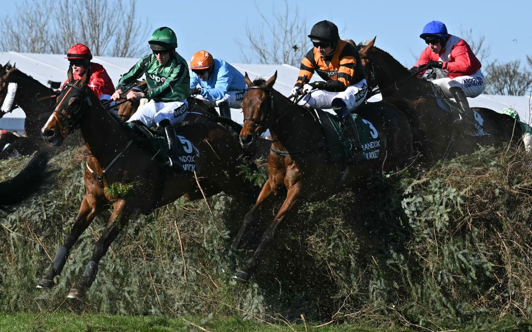 Jockey Patrick Mullins (2R) riding Nick Rockett on the way to winning the Grand National at Aintree Racecourse in Liverpool.