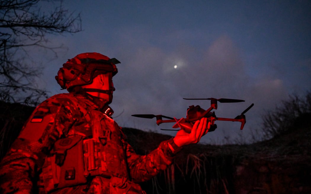 In the Donetsk region, Ukraine, on December 19, 2024, a soldier from the special aerial reconnaissance unit of the National Police of Ukraine, 'Khyzhak,' holds an FPV drone in his hand during hostilities near the city of Toretsk, Donetsk region, eastern Ukraine. NO USE RUSSIA. NO USE BELARUS. (Photo by Ukrinform/NurPhoto) (Photo by Dmytro Smolienko / NurPhoto / NurPhoto via AFP)