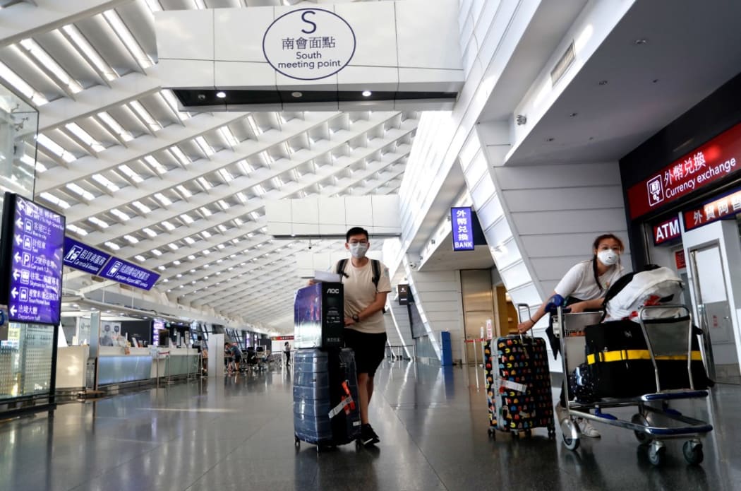 Arriving overseas students wait for a taxi connecting to quarantine hotels, at Taoyuan International Airport, amid COVID-19 pandemic, in Taoyuan, Taiwan, 26 September 2021.