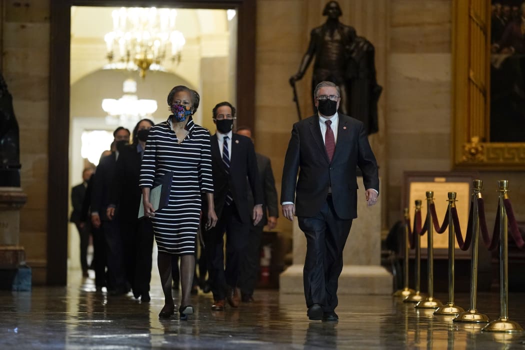 Clerk of the House Cheryl Johnson leads the Democratic House impeachment managers through Statuary Hall to deliver the article of impeachment to the Senate.