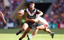 BRISBANE, AUSTRALIA - MAY 07:  Asu Kepaoa of the Wests Tigers is tackled during the round 10 NRL match between Wests Tigers and St George Illawarra Dragons at Suncorp Stadium on May 07, 2023 in Brisbane, Australia. (Photo by Chris Hyde/Getty Images)