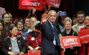 Canada's Prime Minister and Liberal Party leader Mark Carney waves to supporters at a victory party in Ottawa, Ontario on April 29, 2025. Prime Minister Mark Carney won Canada's election on April 28, 2025, leading his Liberal Party to a new term in power after convincing voters his experience managing crises had prepared him to confront US President Donald Trump. (Photo by Dave Chan / AFP)