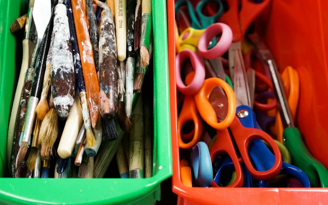 Paintbrushes and craft supplies in a classroom.