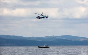 A Greek coast guard vessel and a helicopter take part in a search and rescue operation, after an inflatable boat carrying migrants capsized off on the Aegean Sea island of Lesbos on April 3, 2025.