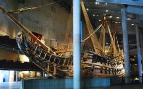 A large wooden warship within a museum.