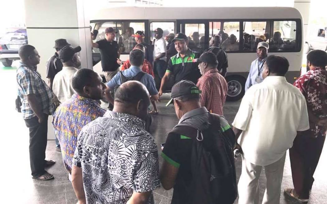 Pangu Pati leader Sam Basil rallies his allies onto a bus. Mr Basil's party hopes to join with the National Alliance to overthrow the government of Peter O'Neill.
