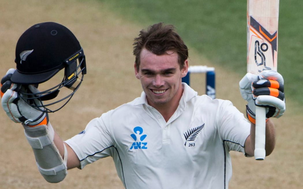 Tom Latham celebrates his century.