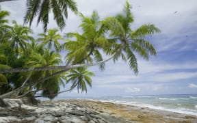 A Tuvalu beach being eroded by a storm.