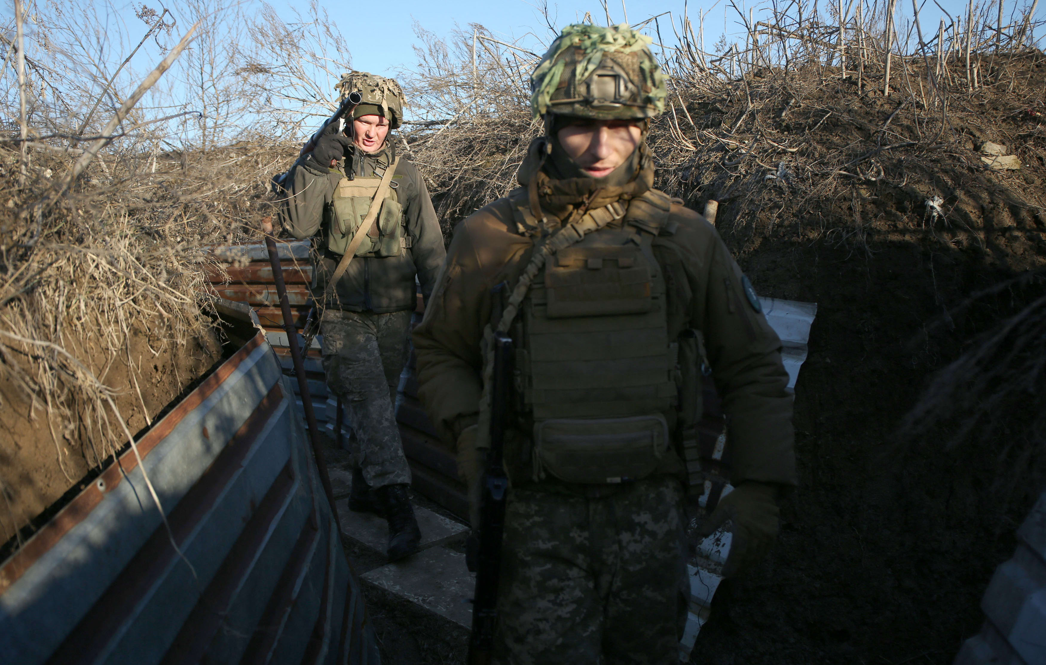 Ukrainian Territorial Defense Forces, the military reserve of the Ukrainian Armes Forces walk on a trench on the frontline facing Russia-backed separatists near to Avdiivka, southeastern Ukraine, on Saturday.