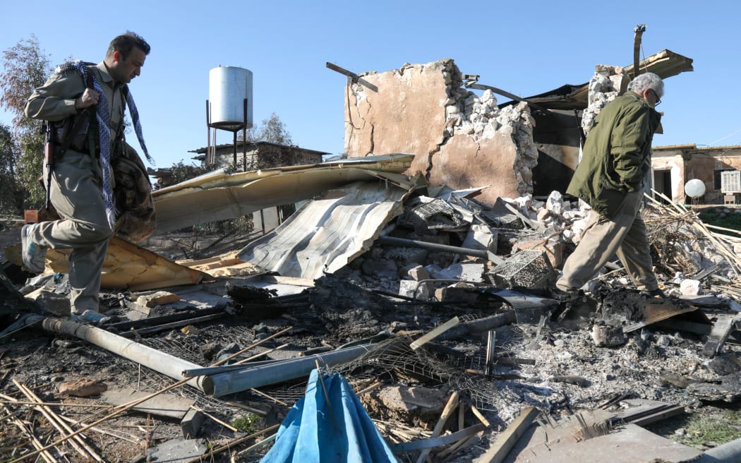 An Iranian Kurdish Peshmerga member of the Kurdistan Democratic Party of Iran (KDPI) inspects damage sustained at the Azadi Camp of the Kurdistan Democratic Party of Iran (KDPI) following an Iranian cross-border attack in the town of Koye (Koysinjaq), in the east of Erbil district in the autonomous Kurdish region of northern Iraq on March 3, 2026. The United States and Israel launched strikes against Iran on February 28, with the killing of Iran's supreme leader and the Islamic republic retaliated with barrages of missiles at Gulf states and Israel. The Kurdistan region hosts US-led coalition troops, and its capital Erbil is home to a major US consulate complex. (Photo by Safin HAMID / AFP)