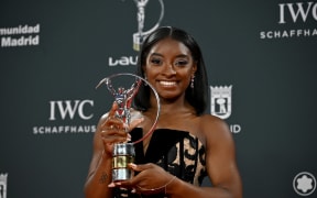 US gymnast Simone Biles poses with her Sportswoman of the Year Award during the 26th Laureus World Sports Awards gala in Madrid on April 21, 2025. (Photo by JAVIER SORIANO / AFP)
