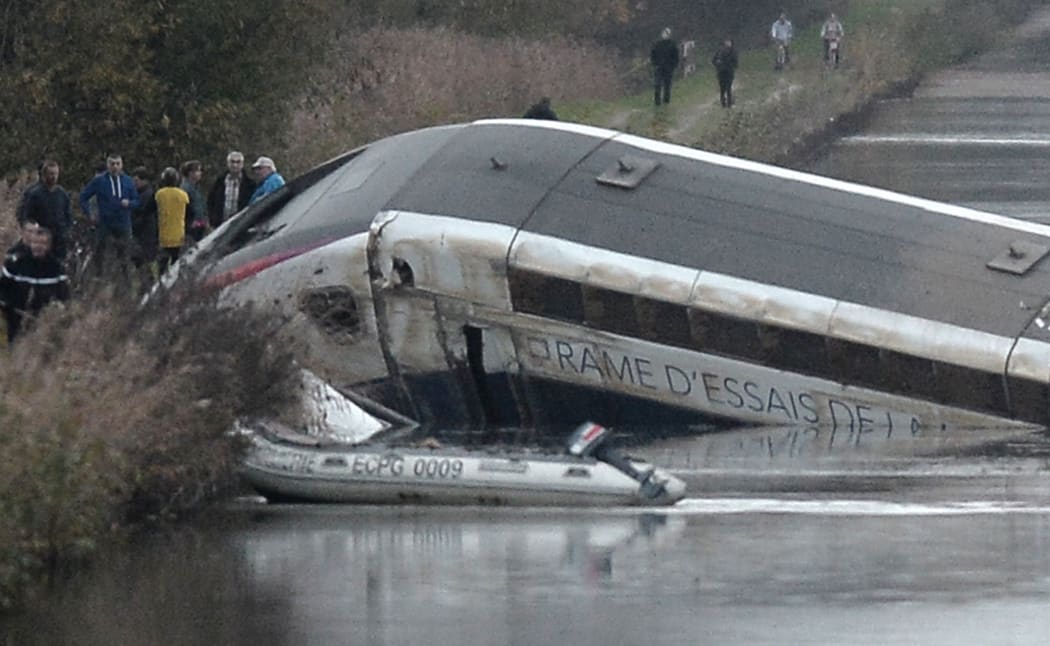 The high-speed TGV train lies partly submerged in a canal near Strasbourg, northeastern France.