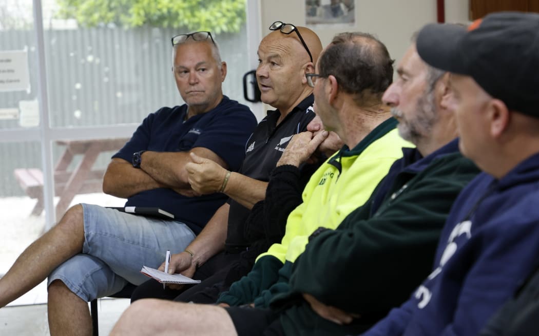 Livestock contractor Robbie Peat asking questions during a community meeting in Okiwi Bay to discuss recent flooding and storm damage.